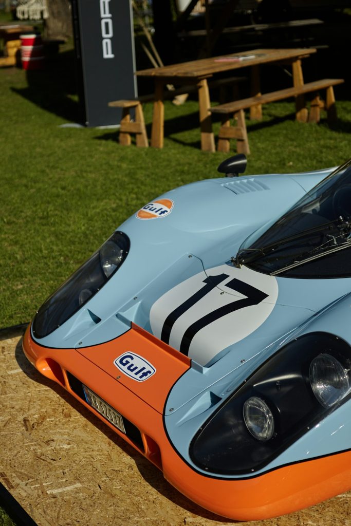 a-blue-and-orange-race-car-sitting-on-top-of-a-field-fta-jknmlg