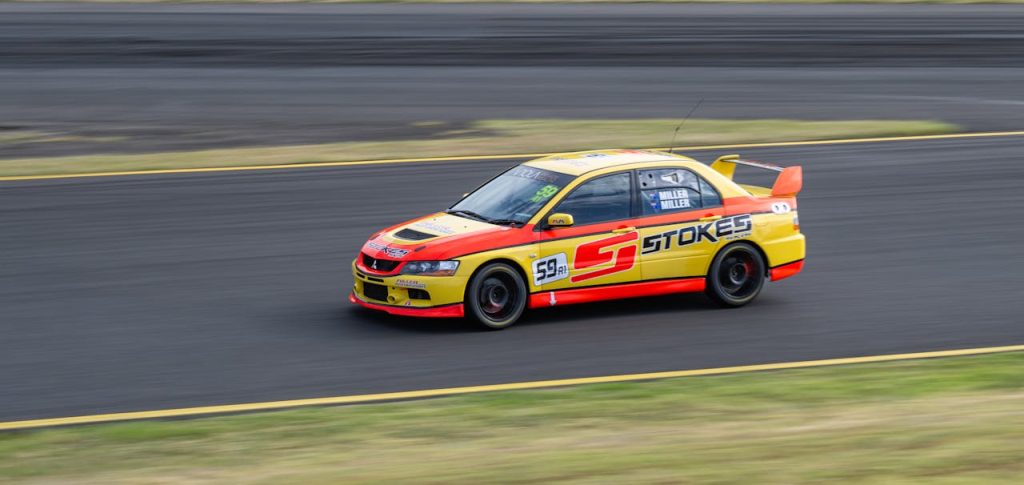 yellow-and-red-race-car-on-track-at-high-speed-34557917